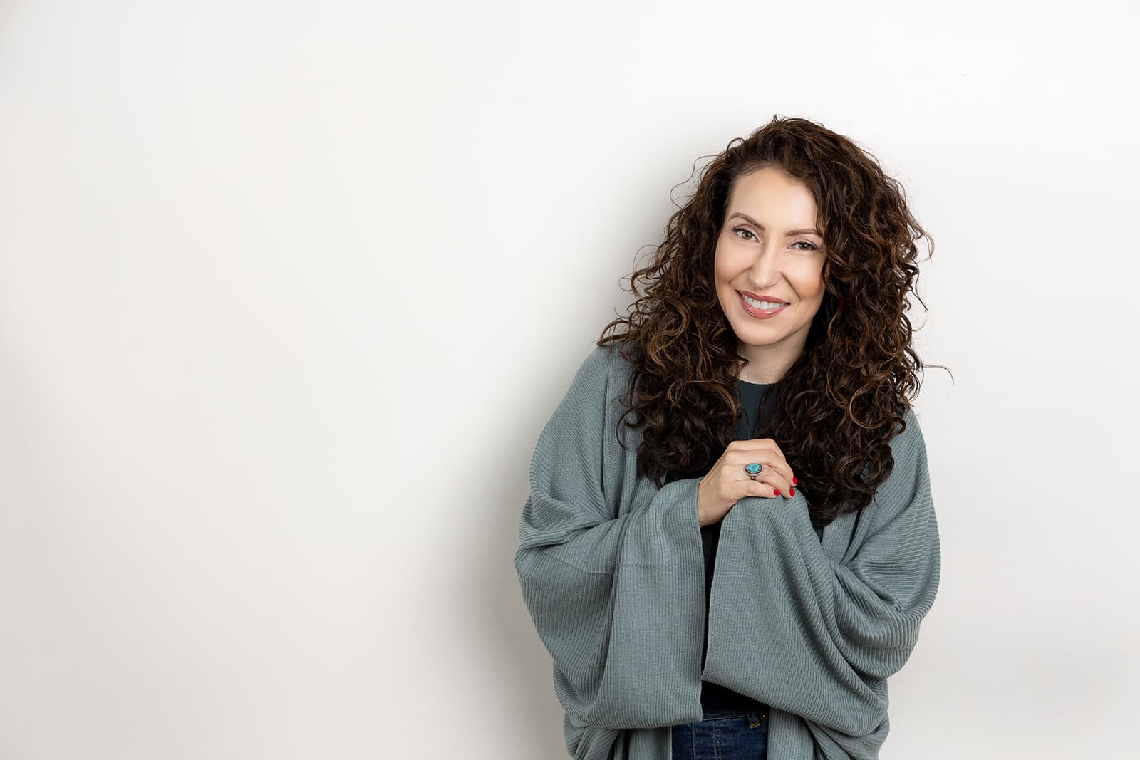 a woman with curly hair posing for a photo.