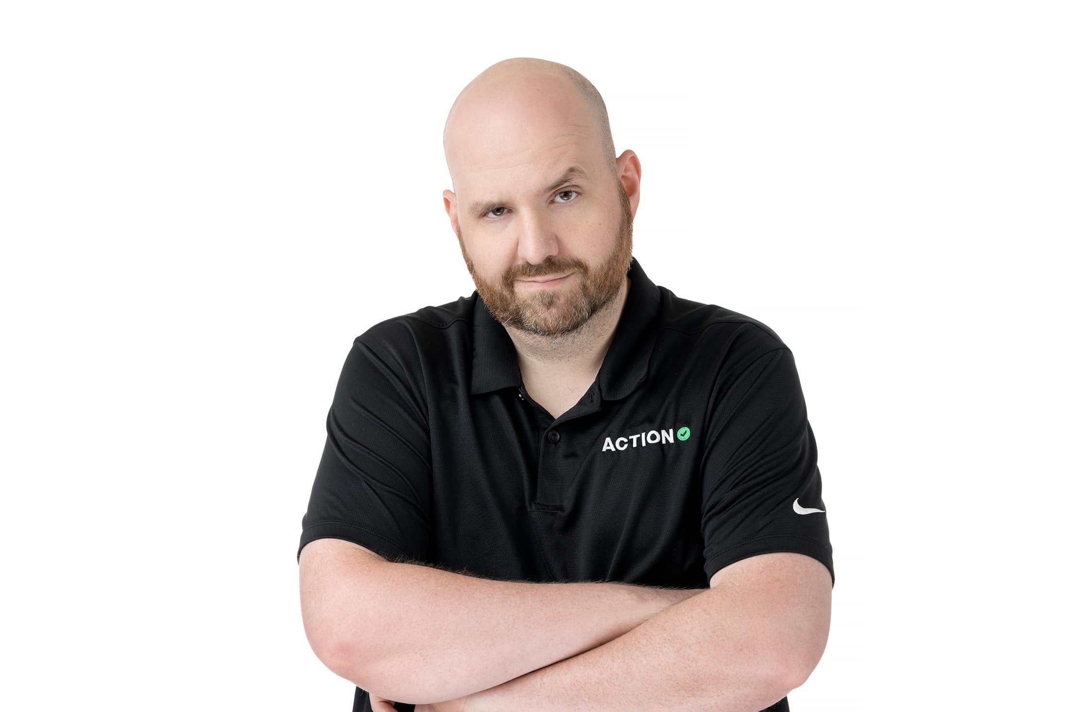 a bald man in a black shirt with his arms crossed.