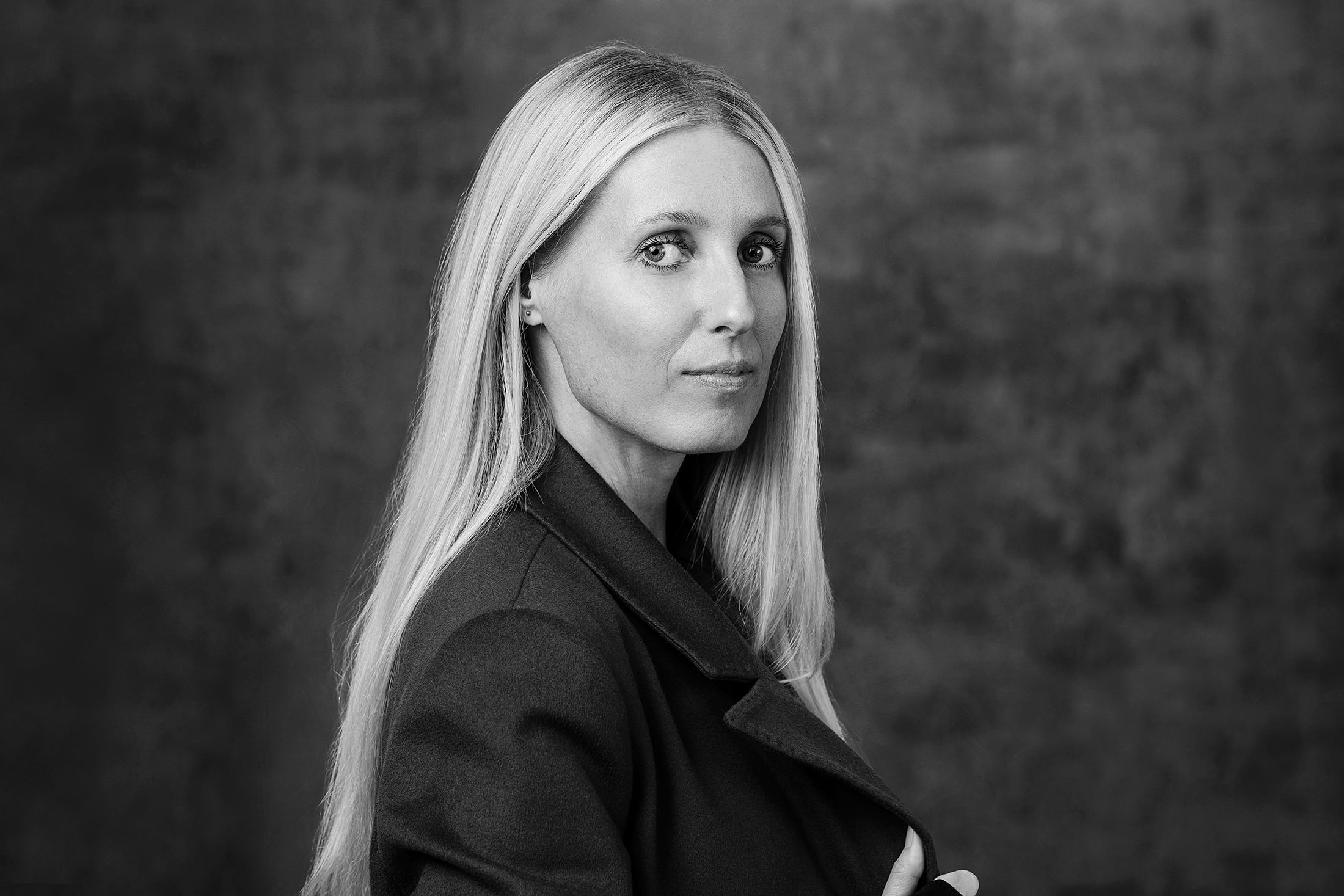 a black and white photo of a woman in a suit.