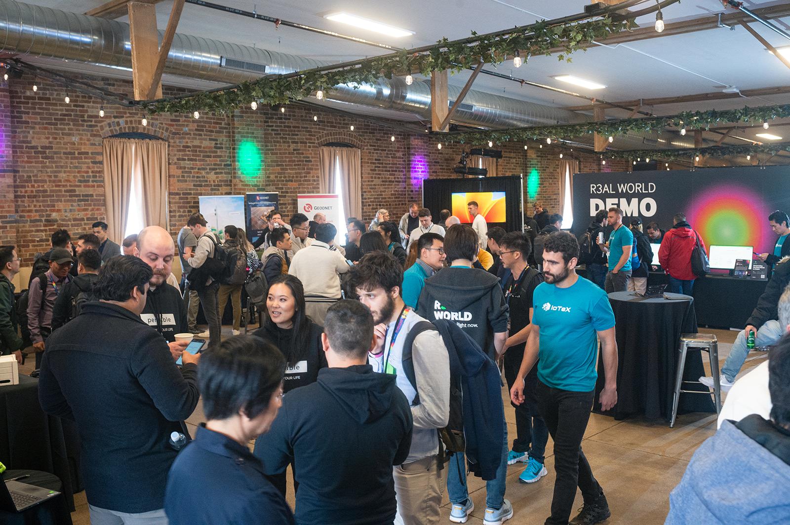 a group of people standing around at a corporate event.