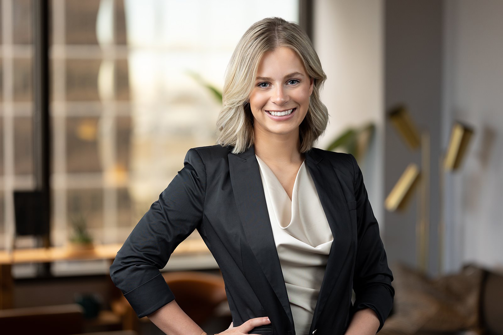 a business woman in a suit standing in an office.