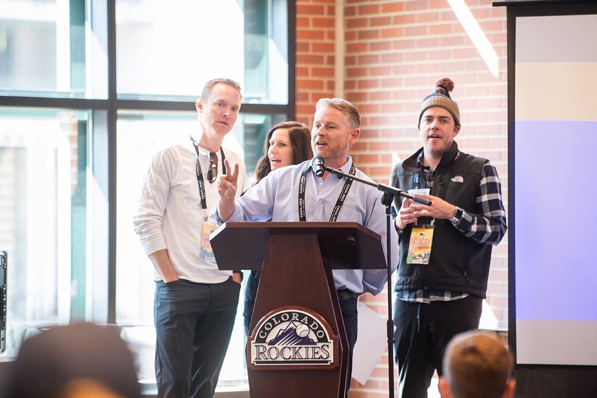 a group of people standing in front of a podium.