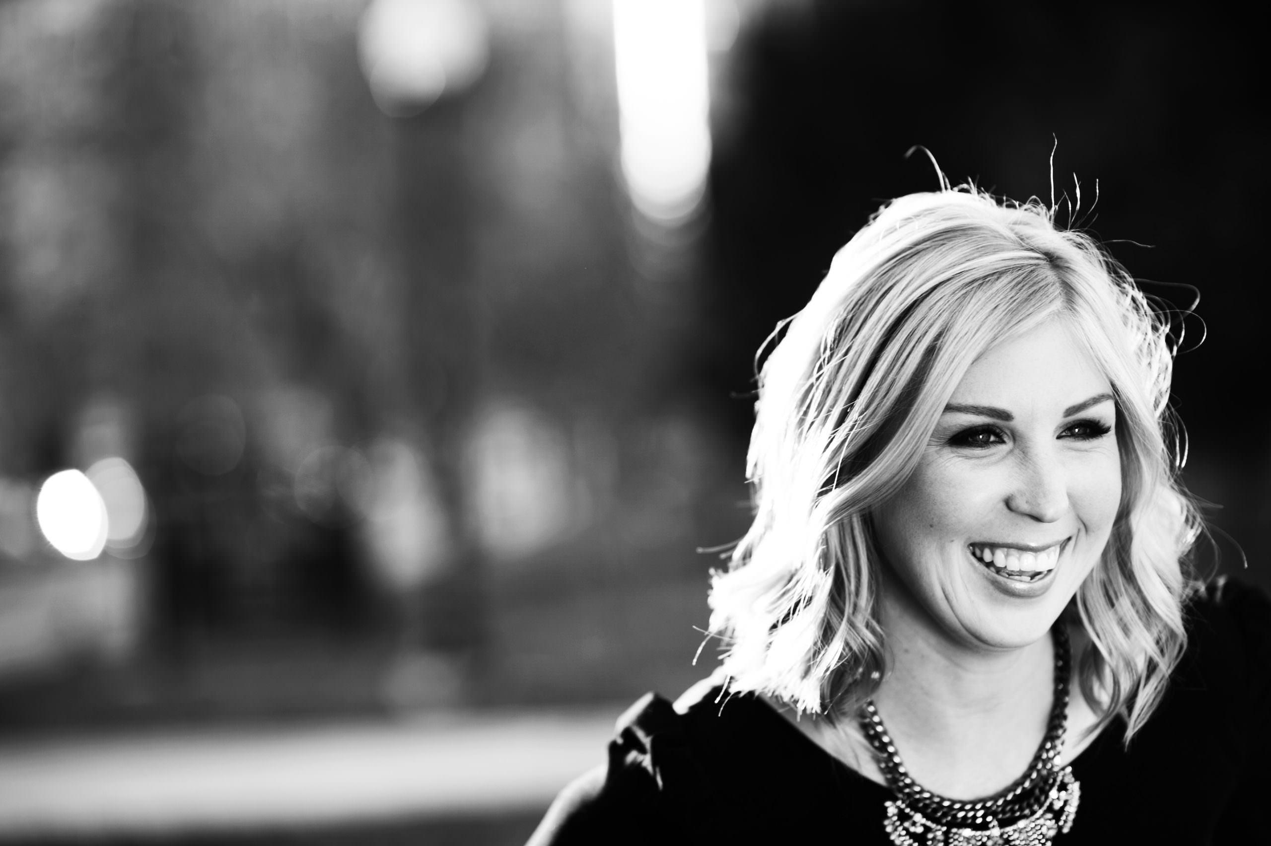 a black and white photo of a woman smiling.