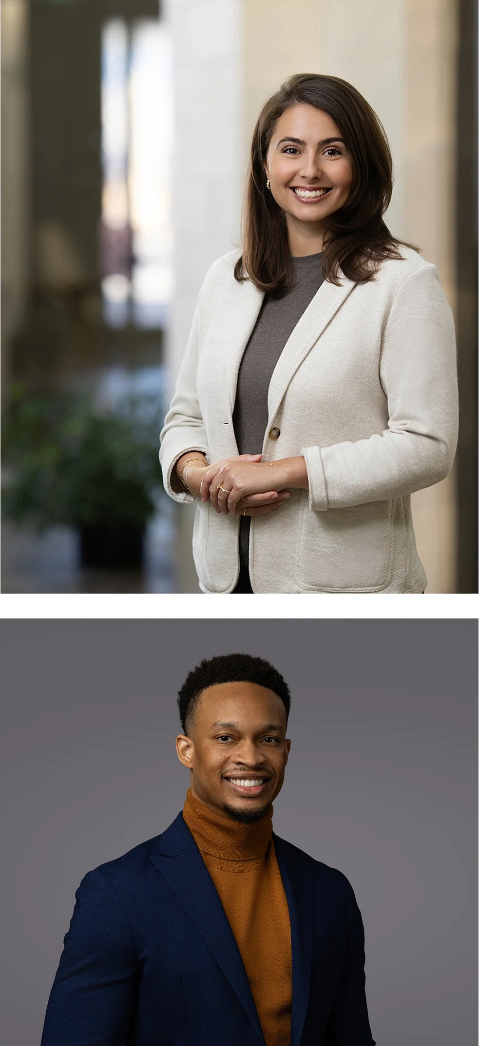 A woman in a light blazer and a man in a dark suit jacket with a brown turtleneck both pose and smile for professional photos.