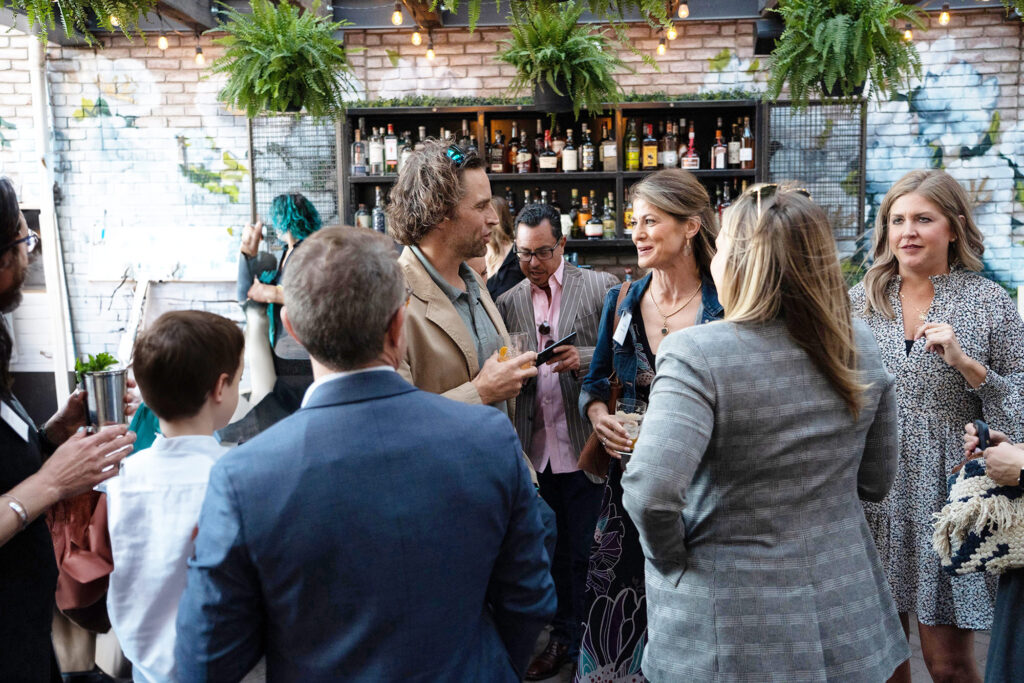 Event Photography: People conversing at a gathering.