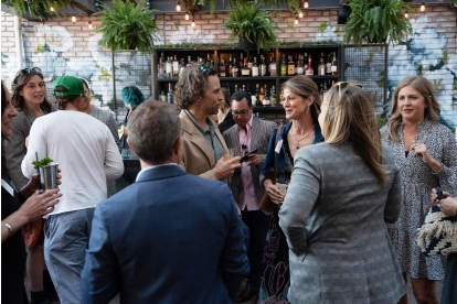 a group of people talking at an event.
