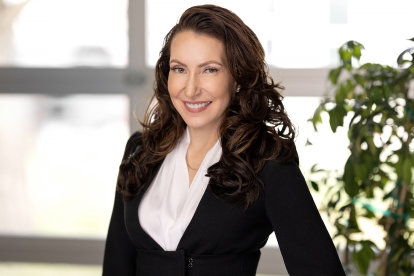 a woman in a business suit posing for a photo.