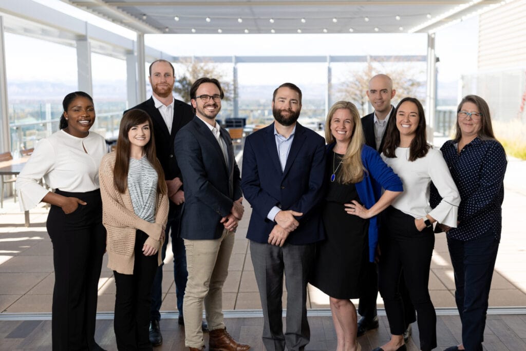 a group of business people posing for a photo.