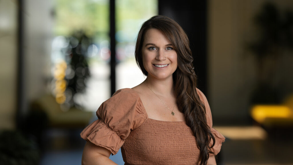 Woman flaunting a side hairstyle, ready for her professional headshot session.