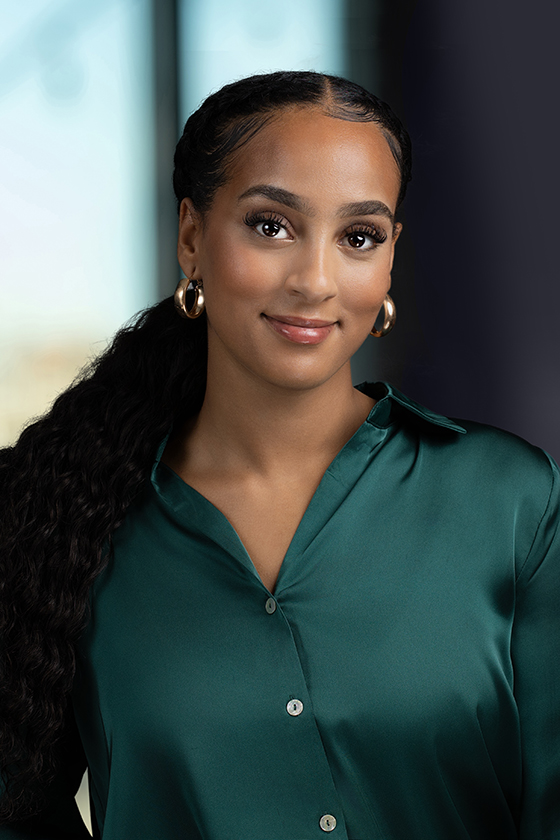 headshot of woman in green blouse