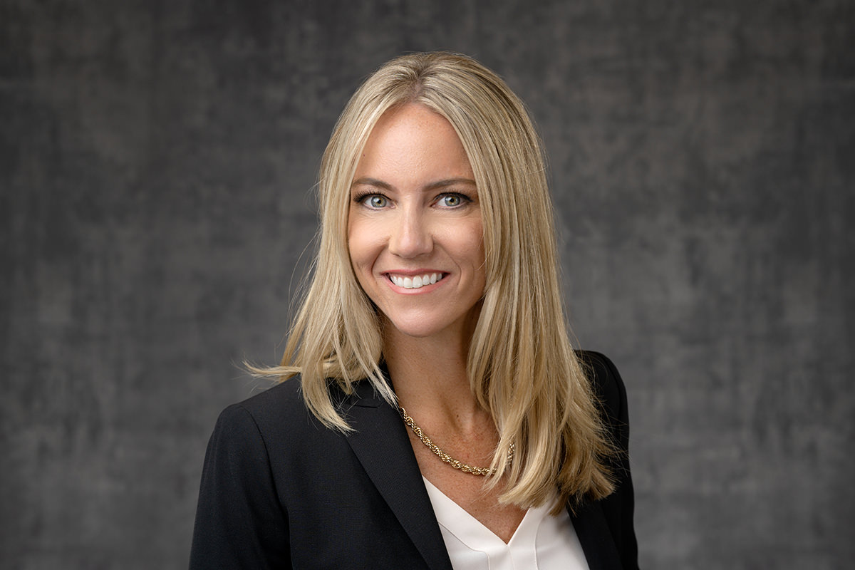 Professional woman smiling in her Denver headshots studio portrait.